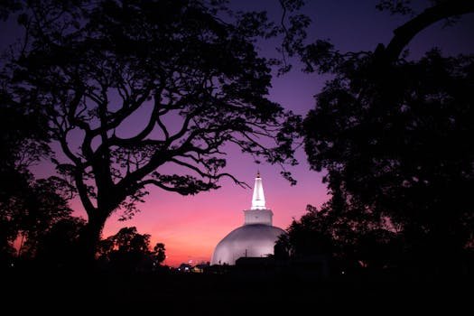 Stunning view of the Ruwanweli Maha Seya stupa against a vibrant twilight sky in Anuradhapura, Sri Lanka.